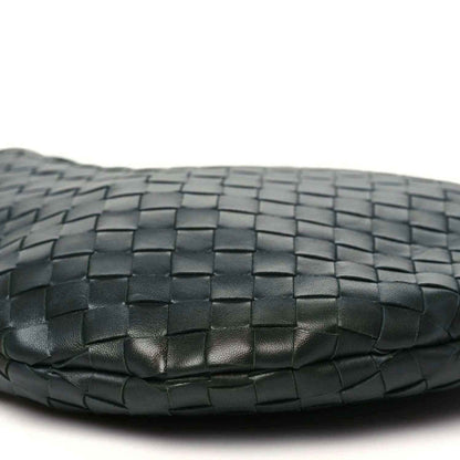 Close-up of dark green woven leather base with subtle creases