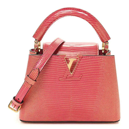 Louis Vuitton mini handbag front, fuchsia textured lizard, gold V emblem, handles.