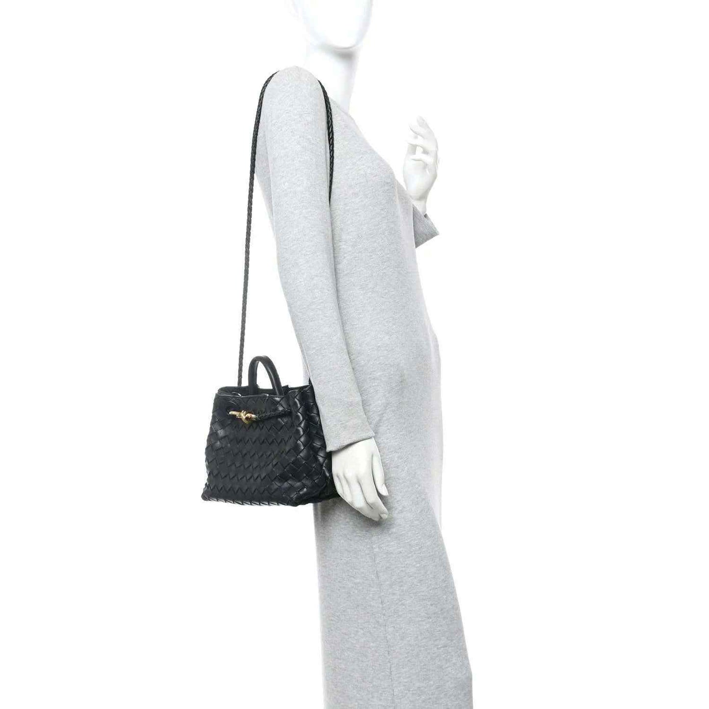 Black woven leather mini shoulder bag worn with a thin crossbody strap