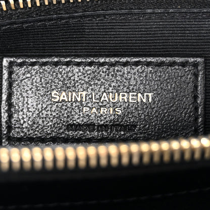 Black satchel interior leather label reading SAINT LAURENT PARIS, gold zipper edge