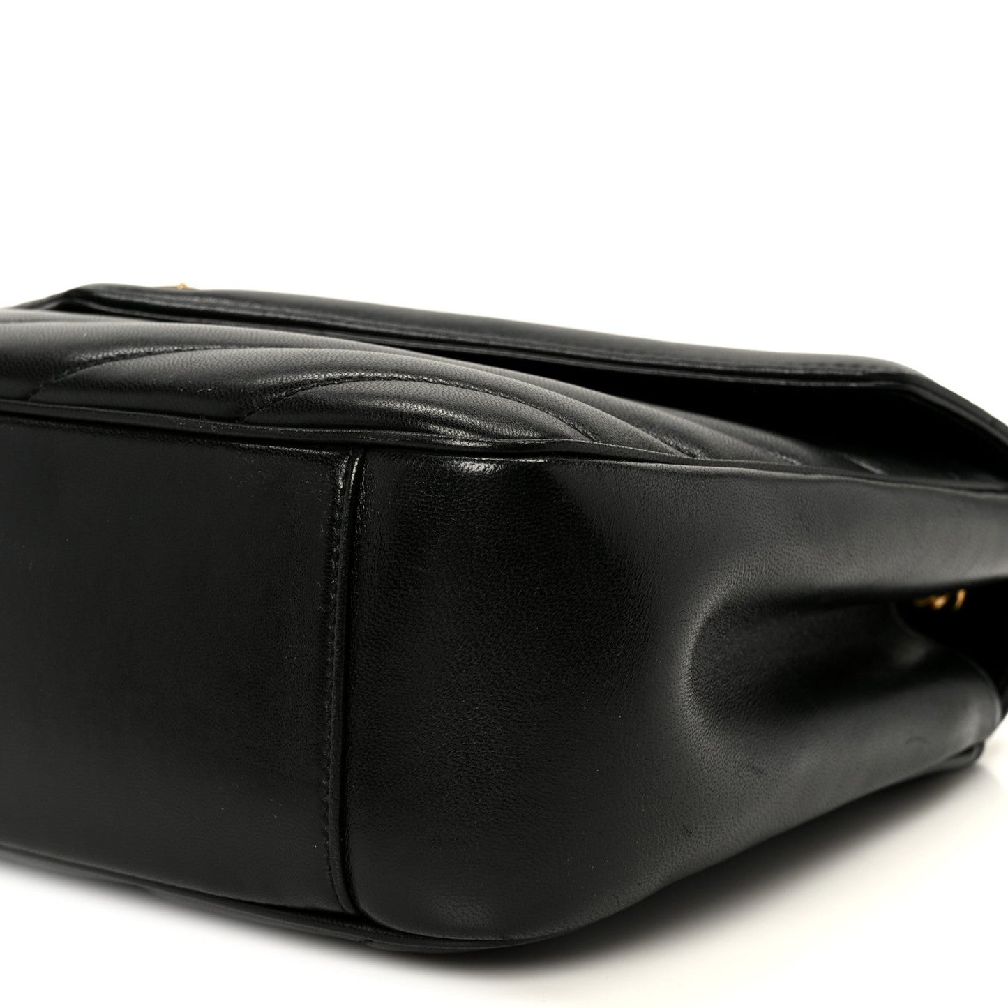 Black leather shoulder bag side with stitched trim and rounded base