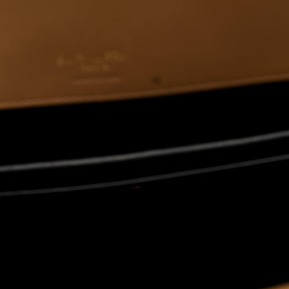 Close-up showing dark interior area with natural tan leather trim