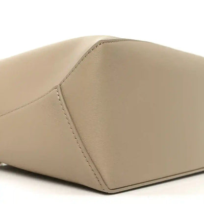 Small Puzzle edge bag corner detail, smooth beige calfskin with edge stitching