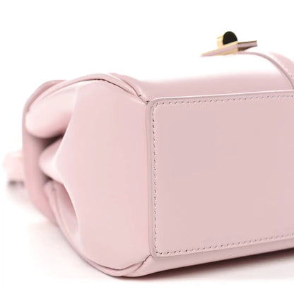 Pastel pink mini bag corner detail with rounded side and top handle base
