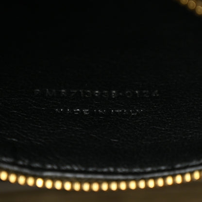 Engraved brand text and code on leather surface with fine stitching.