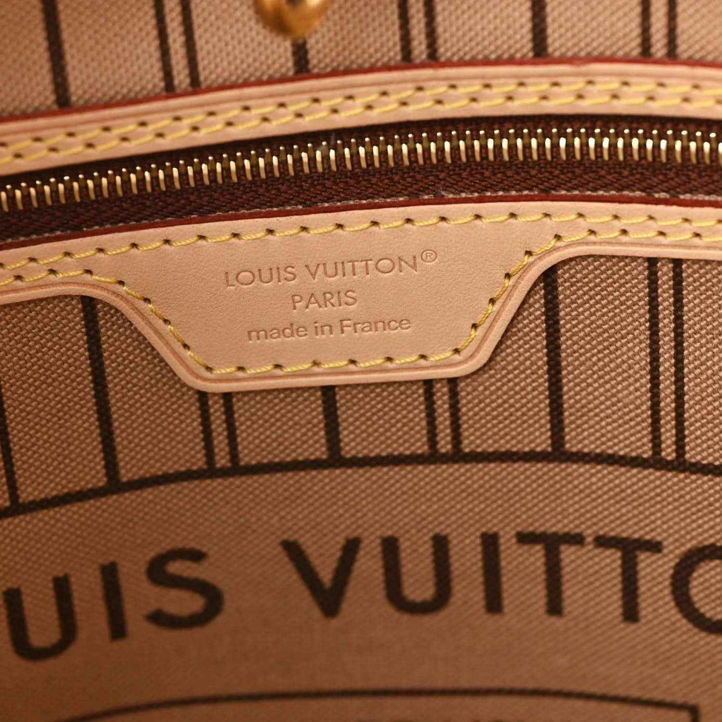 Louis Vuitton tote interior label reading 'made in France' with stitched trim