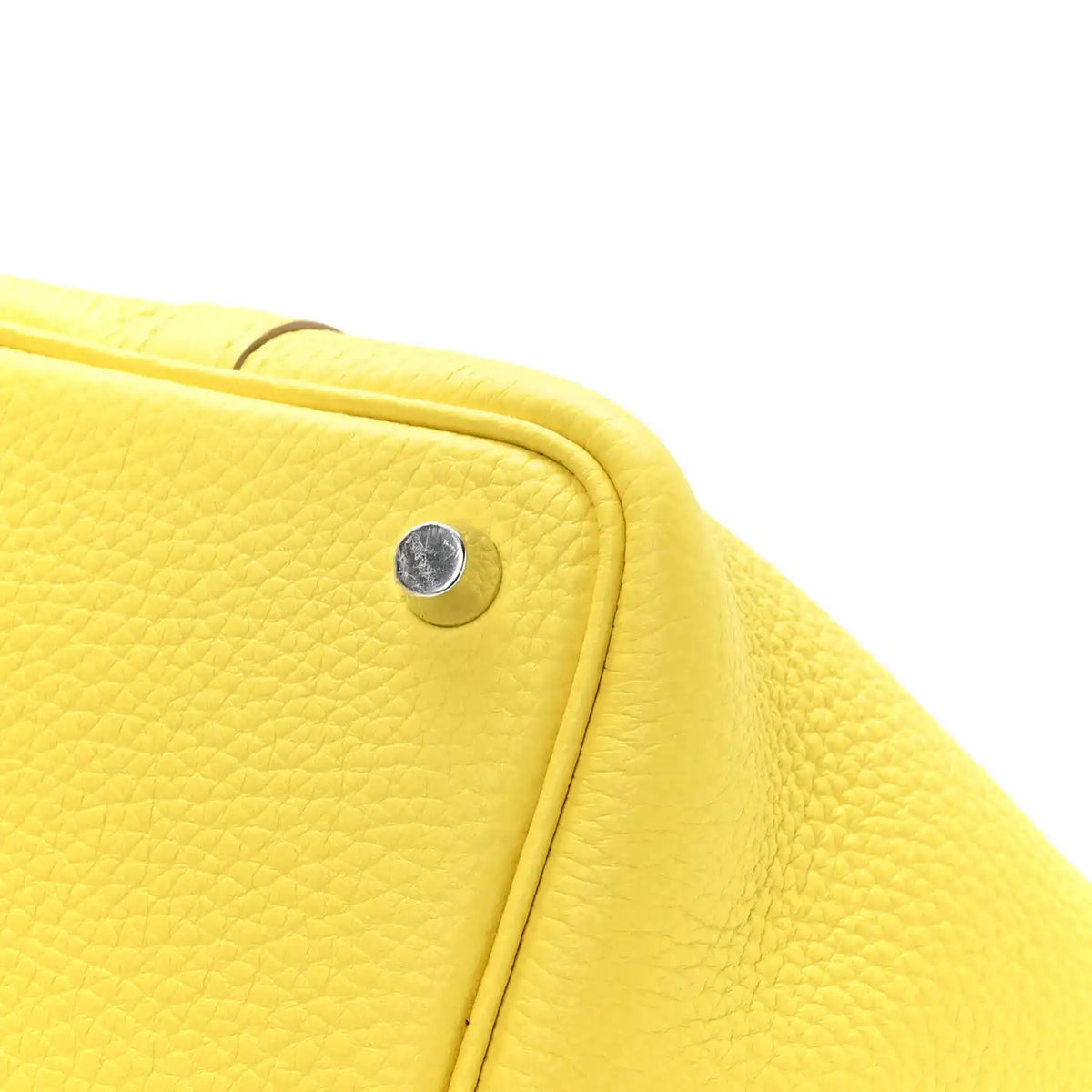 Lime leather tote side edge with round snap stud and stitched trim