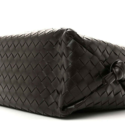 Black woven leather weekender bag corner with stitched detail and loop handle