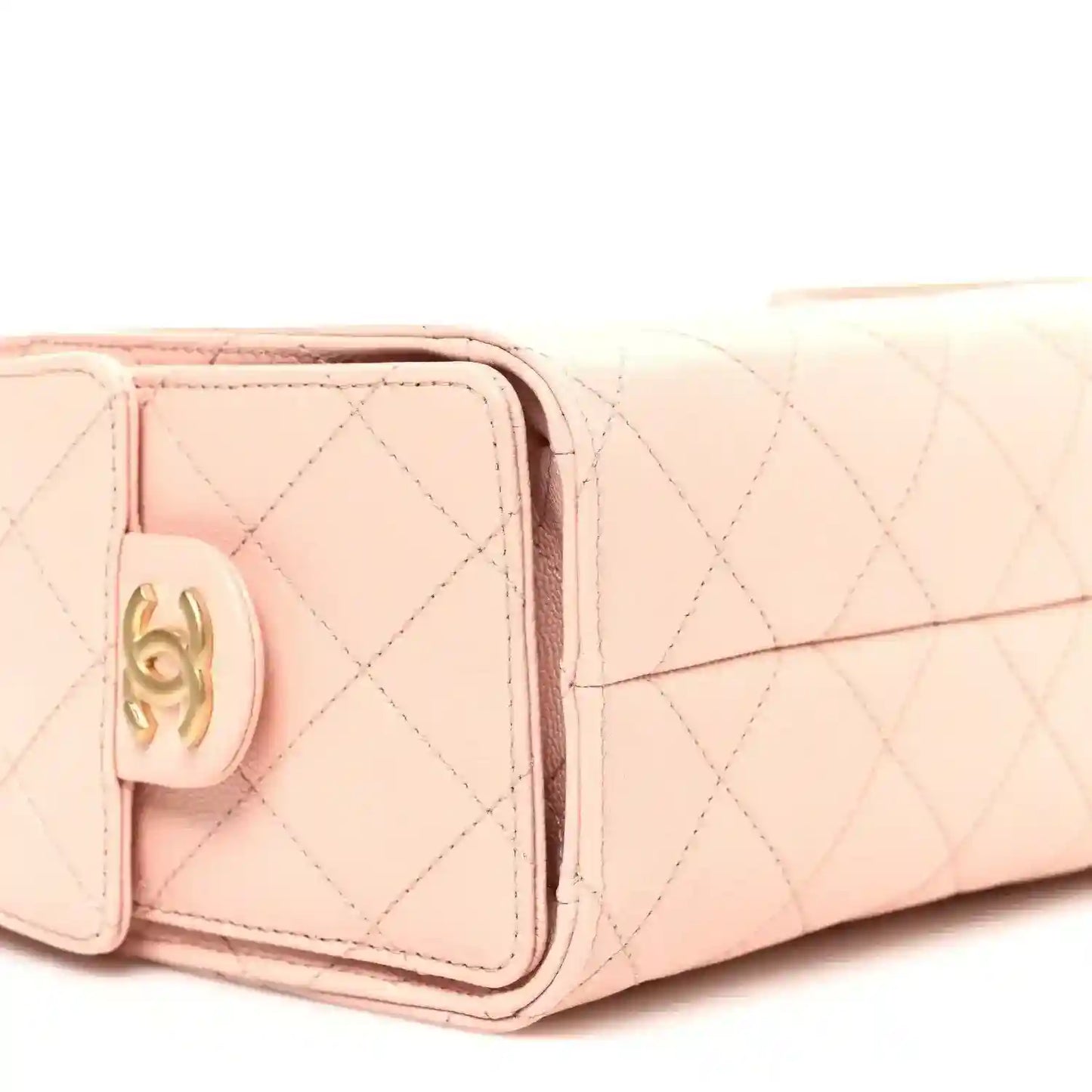 Light pink quilted mini handbag front with gold-tone Chanel logo on leather tab