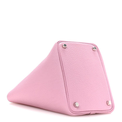 Rose pink leather handbag front corner with metal studs and triangular fold