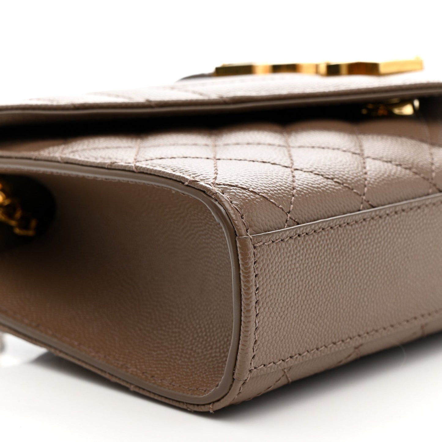 Dark beige quilted satchel corner with smooth leather trim and gold clasp hardware
