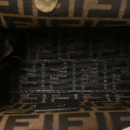 Black leather brand label with FENDI text on small shoulder bag