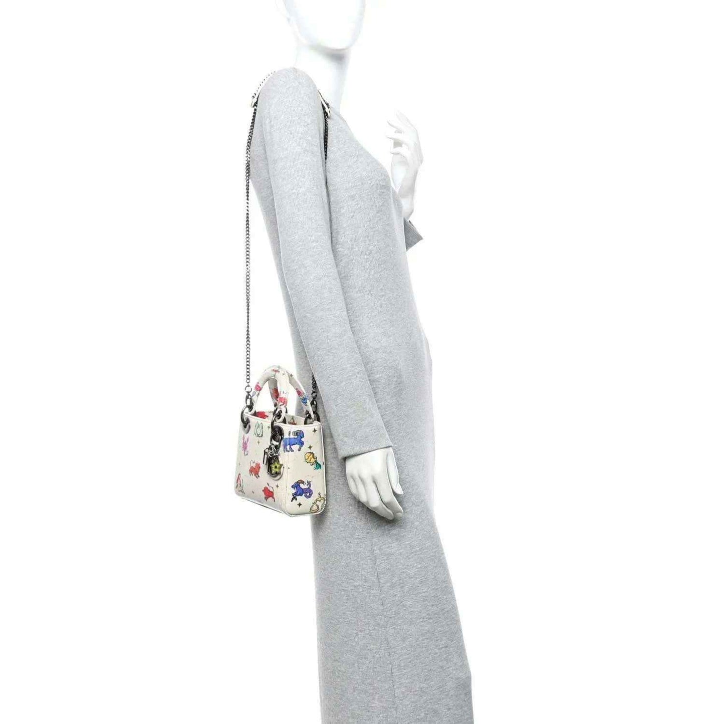 Mini Lady Dior bag on model arm, white pixel zodiac pattern, chain strap