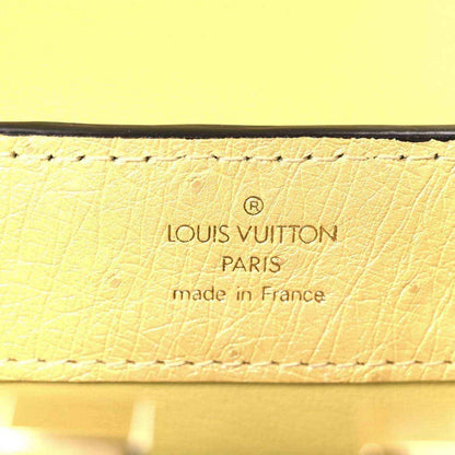 Yellow leather mini bag label reading Louis Vuitton Paris, made in France