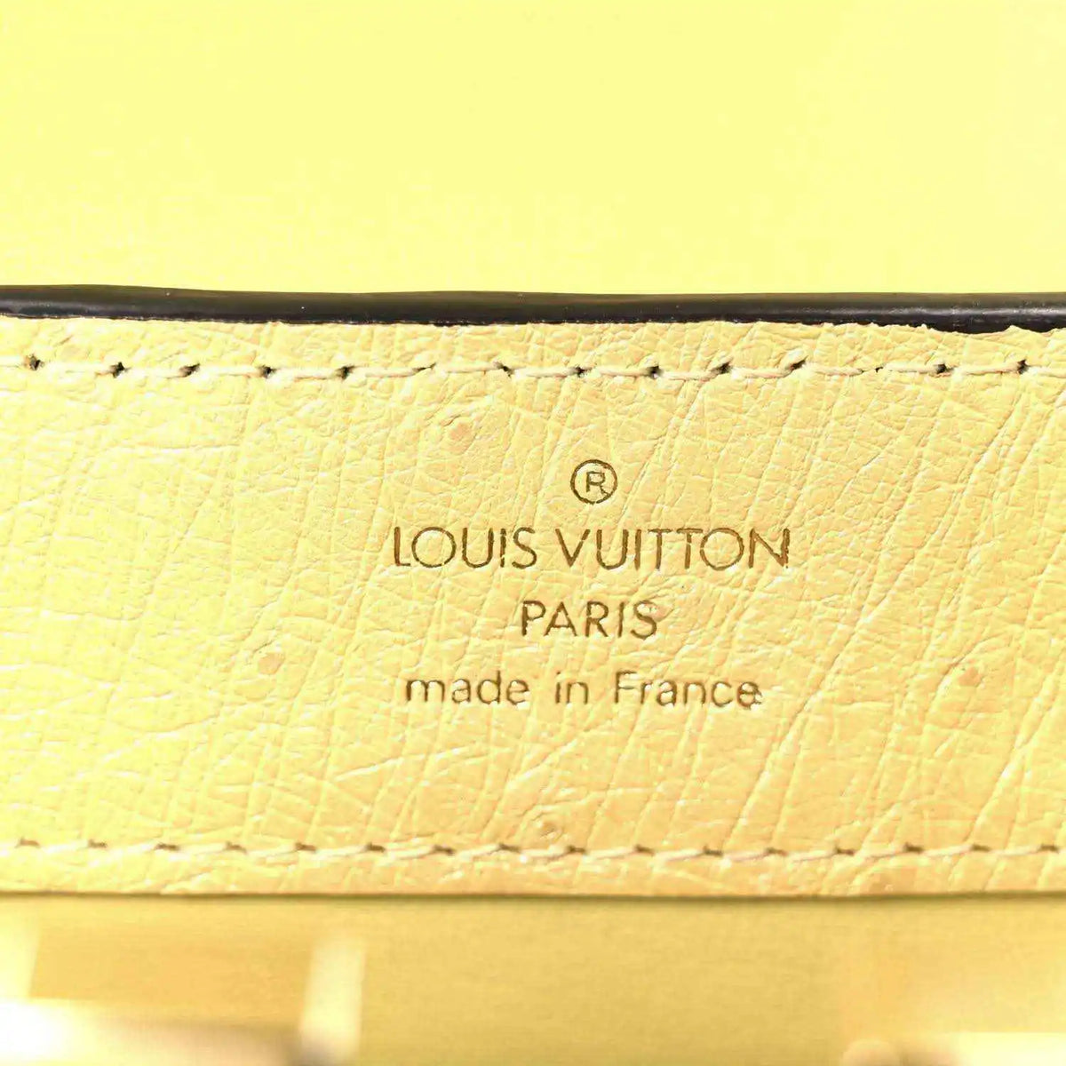 Yellow leather mini bag label reading Louis Vuitton Paris, made in France