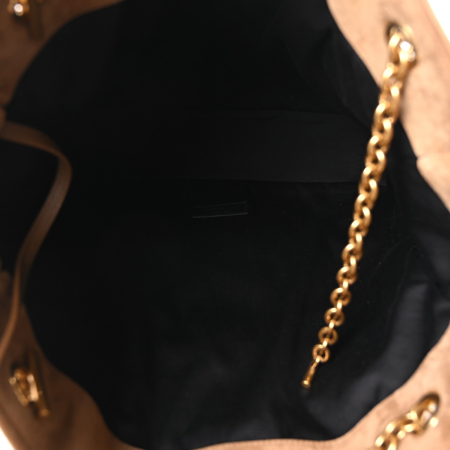 Suede tote interior with black lining and gold chain hardware detail