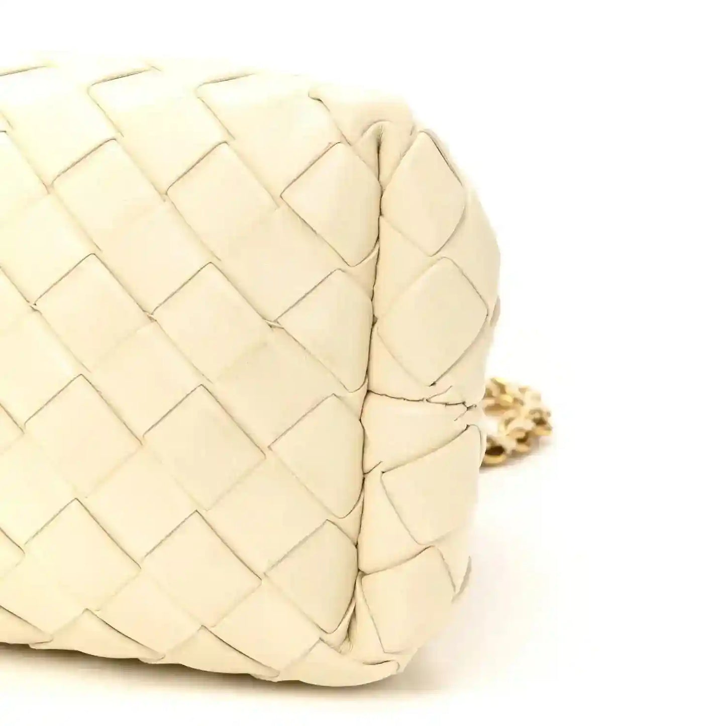 White leather intrecciato clutch texture close-up with gold-tone chain link