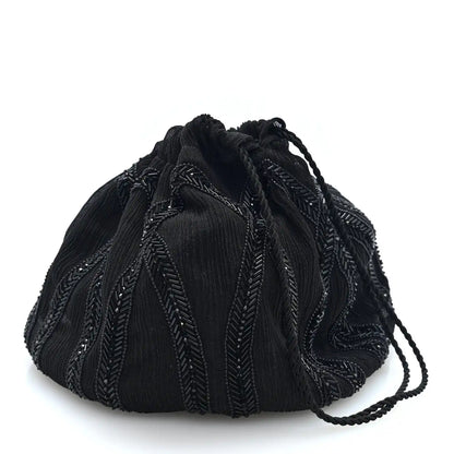 Black beaded drawstring pochon bag with pleated crepe fabric and textured embroidery