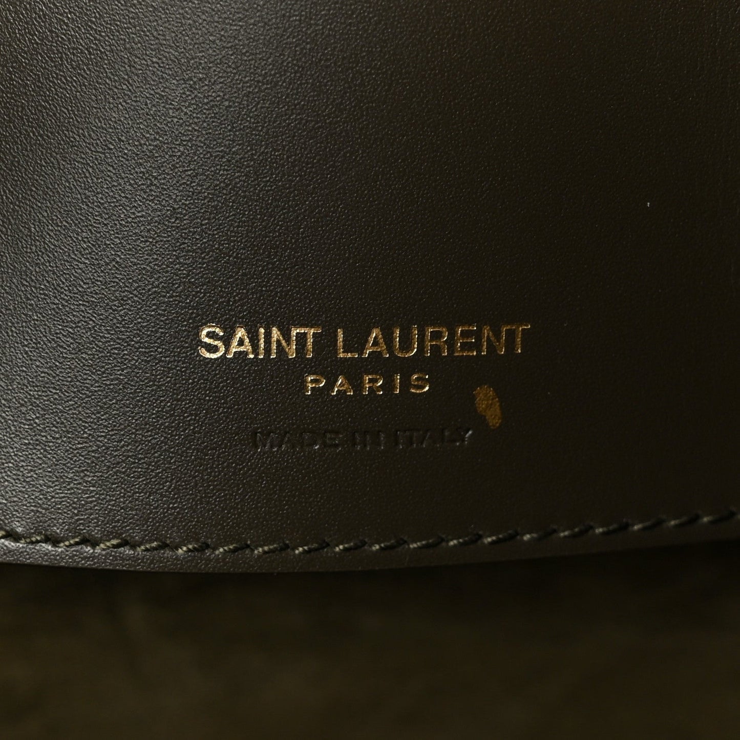 SAINT LAUREN PARIS leather stamp on dark bag lining.