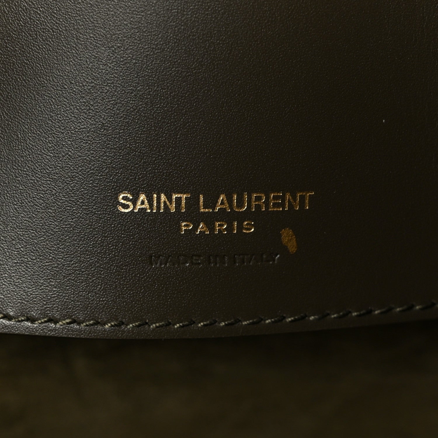 SAINT LAUREN PARIS leather stamp on dark bag lining.