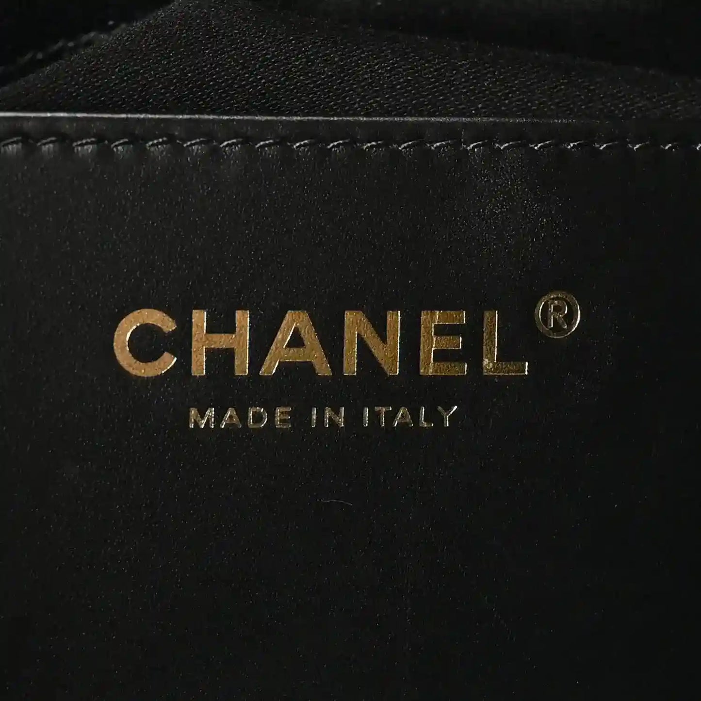 Chanel gold logo and 'MADE IN ITALY' on black leather interior