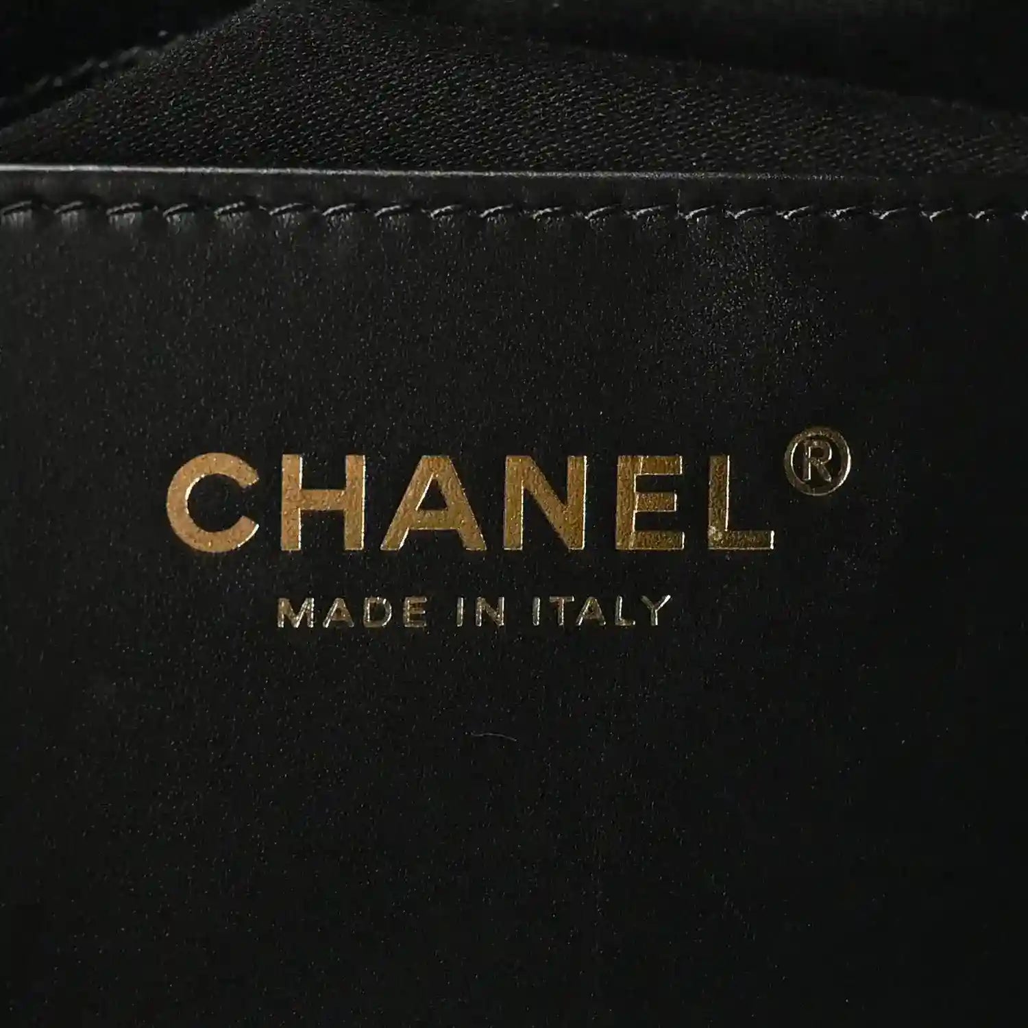 Chanel gold logo and 'MADE IN ITALY' on black leather interior