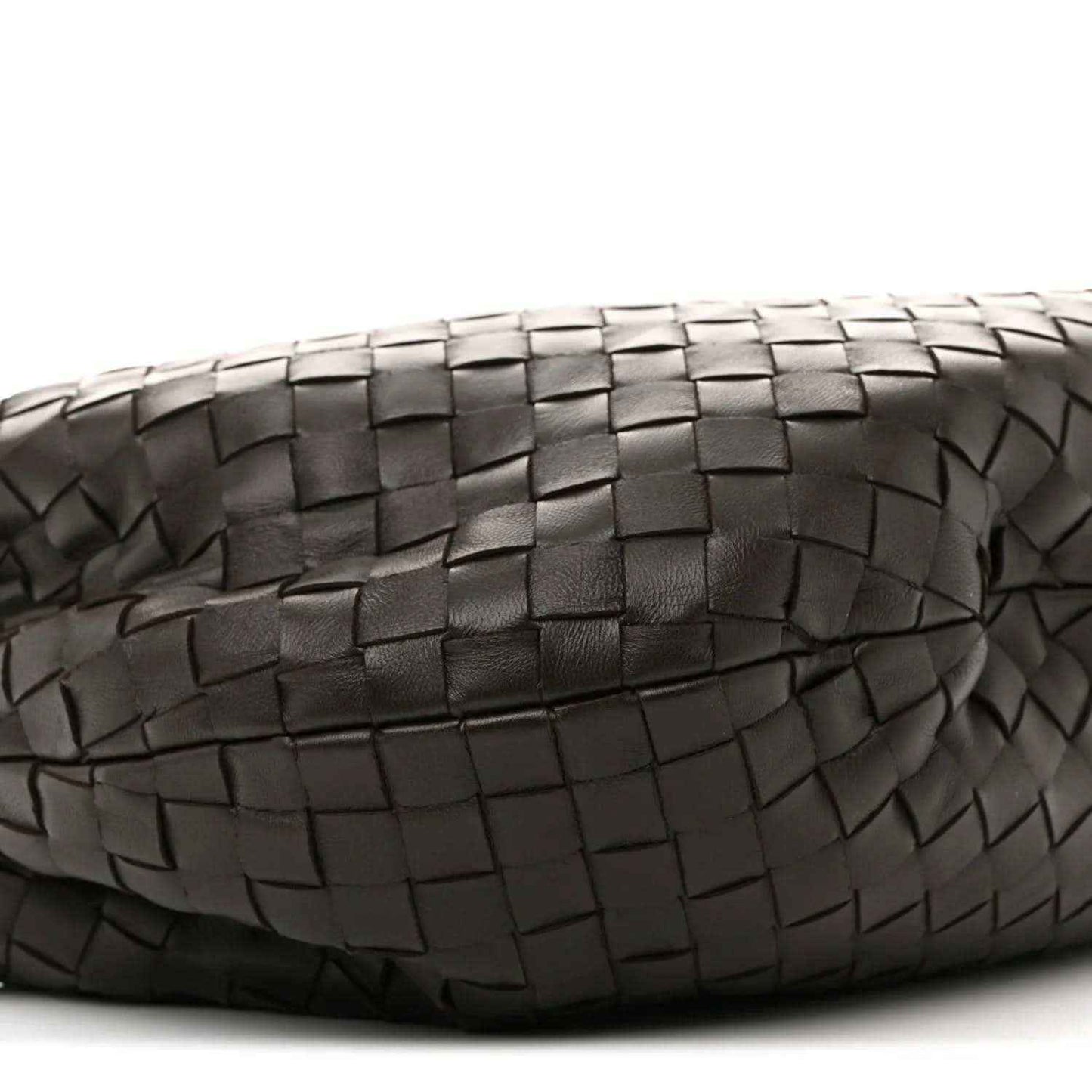 Close-up of woven leather panel with intrecciato squares and zigzag edges