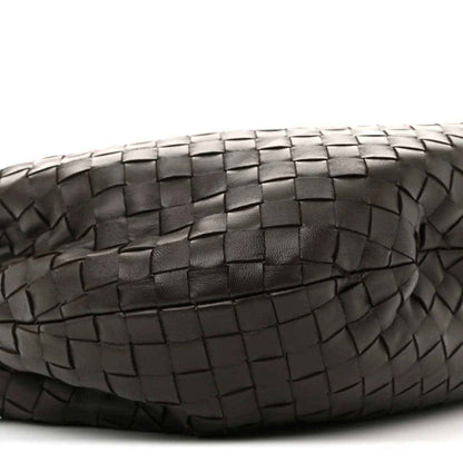 Close-up of woven leather panel with intrecciato squares and zigzag edges
