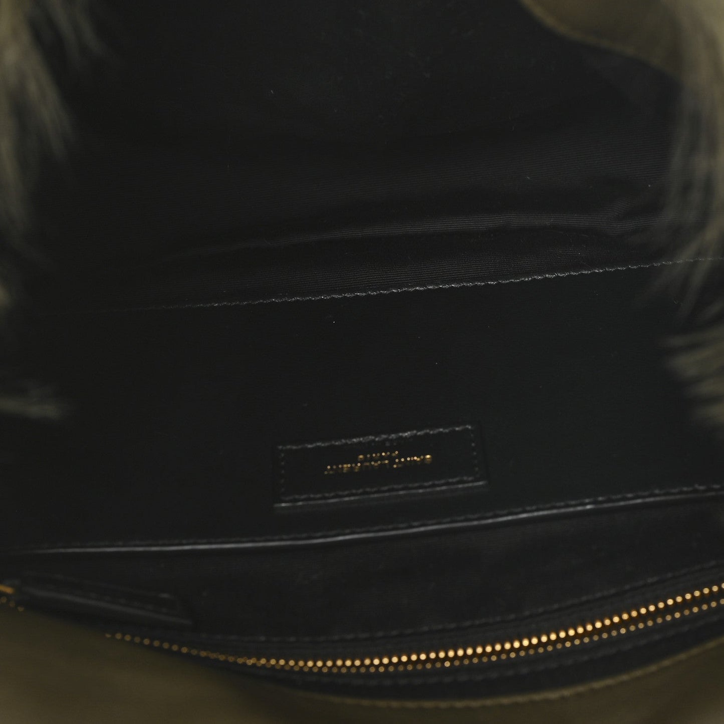 Black leather trim on shearling bag with small logo plaque and contrast stitching