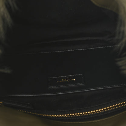 Black leather trim on shearling bag with small logo plaque and contrast stitching