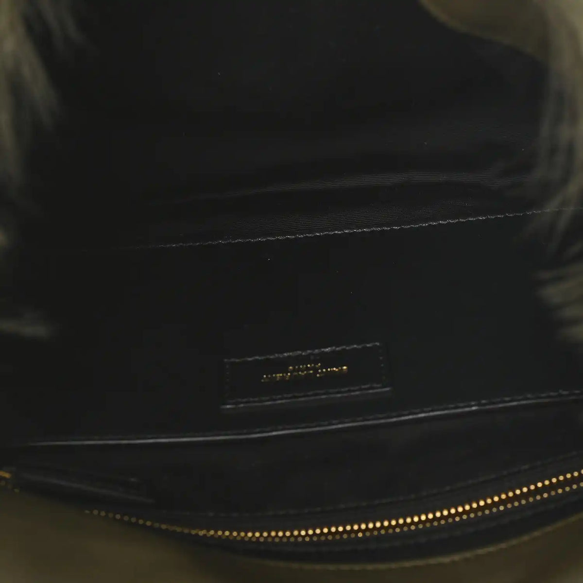Black leather trim on shearling bag with small logo plaque and contrast stitching