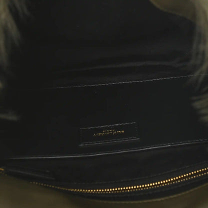 Black leather trim on shearling bag with small logo plaque and contrast stitching