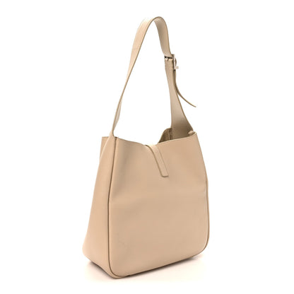 Light beige small hobo bag with slim top handles and front seam detail