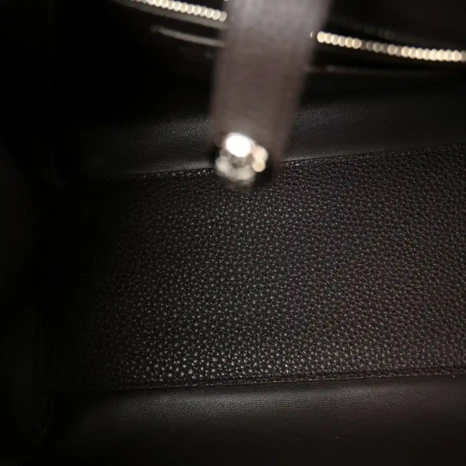 Leather bag interior with zipper track and metal pull tab