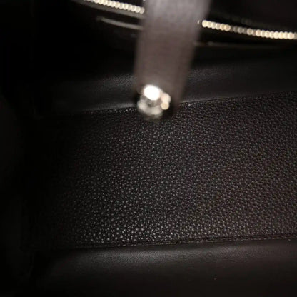 Leather bag interior with zipper track and metal pull tab