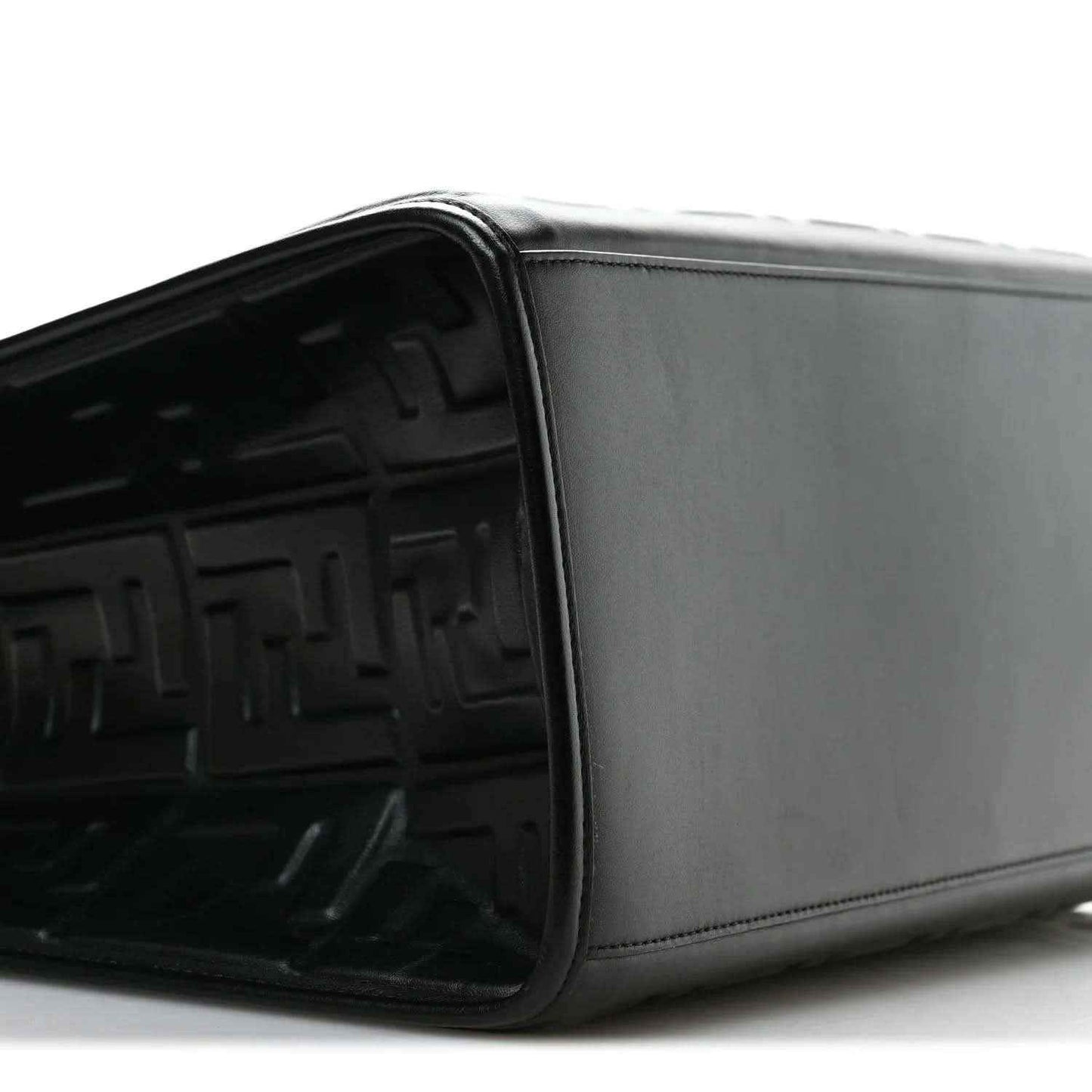 Black leather tote bag side view with smooth panel and embossed FF interior