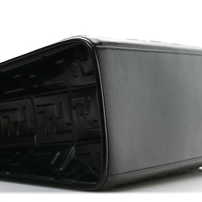 Black leather tote bag side view with smooth panel and embossed FF interior