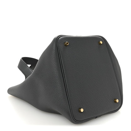 Structured leather handbag in dark gray with gold-toned studs on base corners