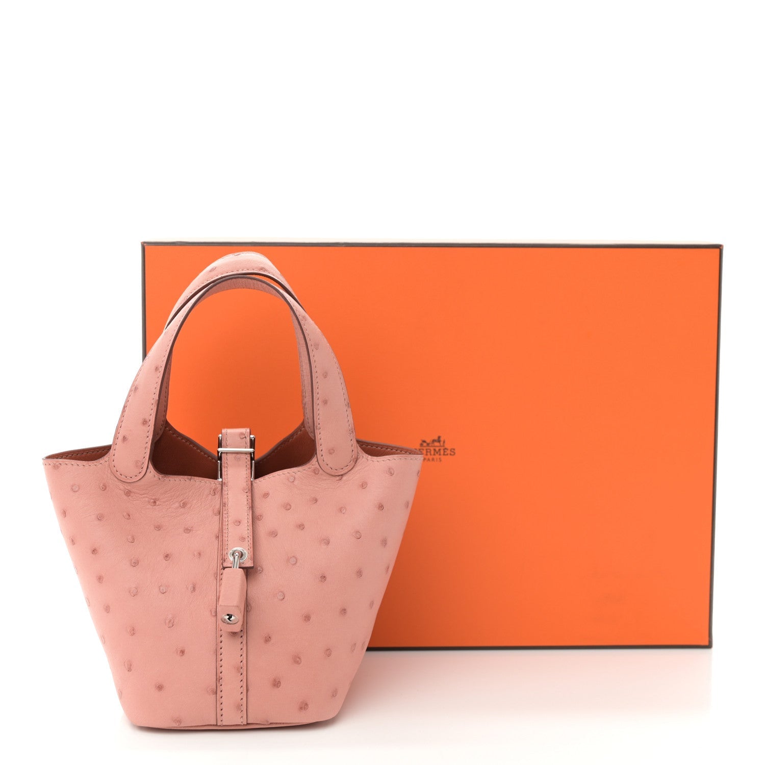 Mini bucket bag in light pink ostrich leather with top handle and silver lock clasp