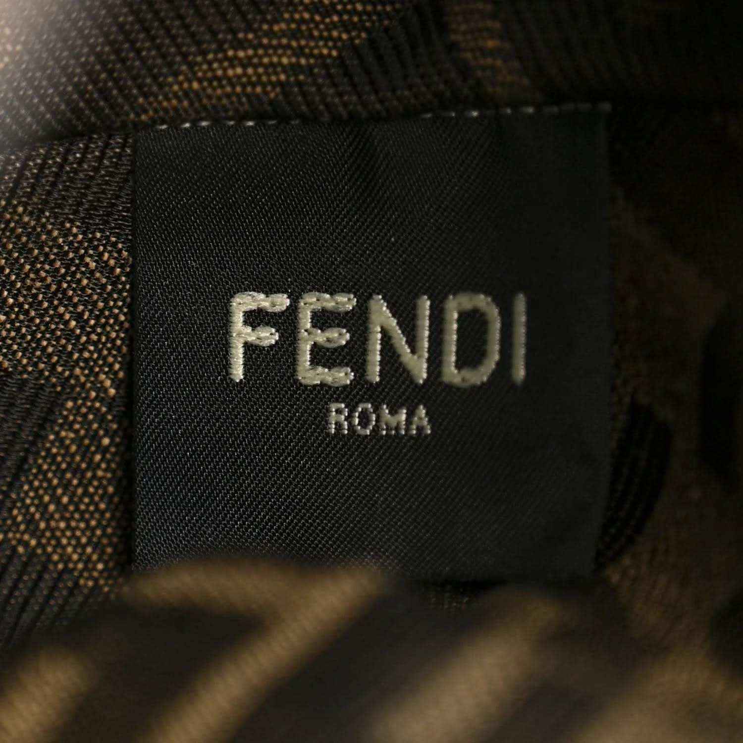 Close-up of FENDI Roma logo patch on dark bag lining.