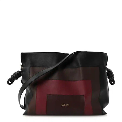 Flamenco knot clutch bag in black Nappa calfskin with burgundy panel and crossbody strap