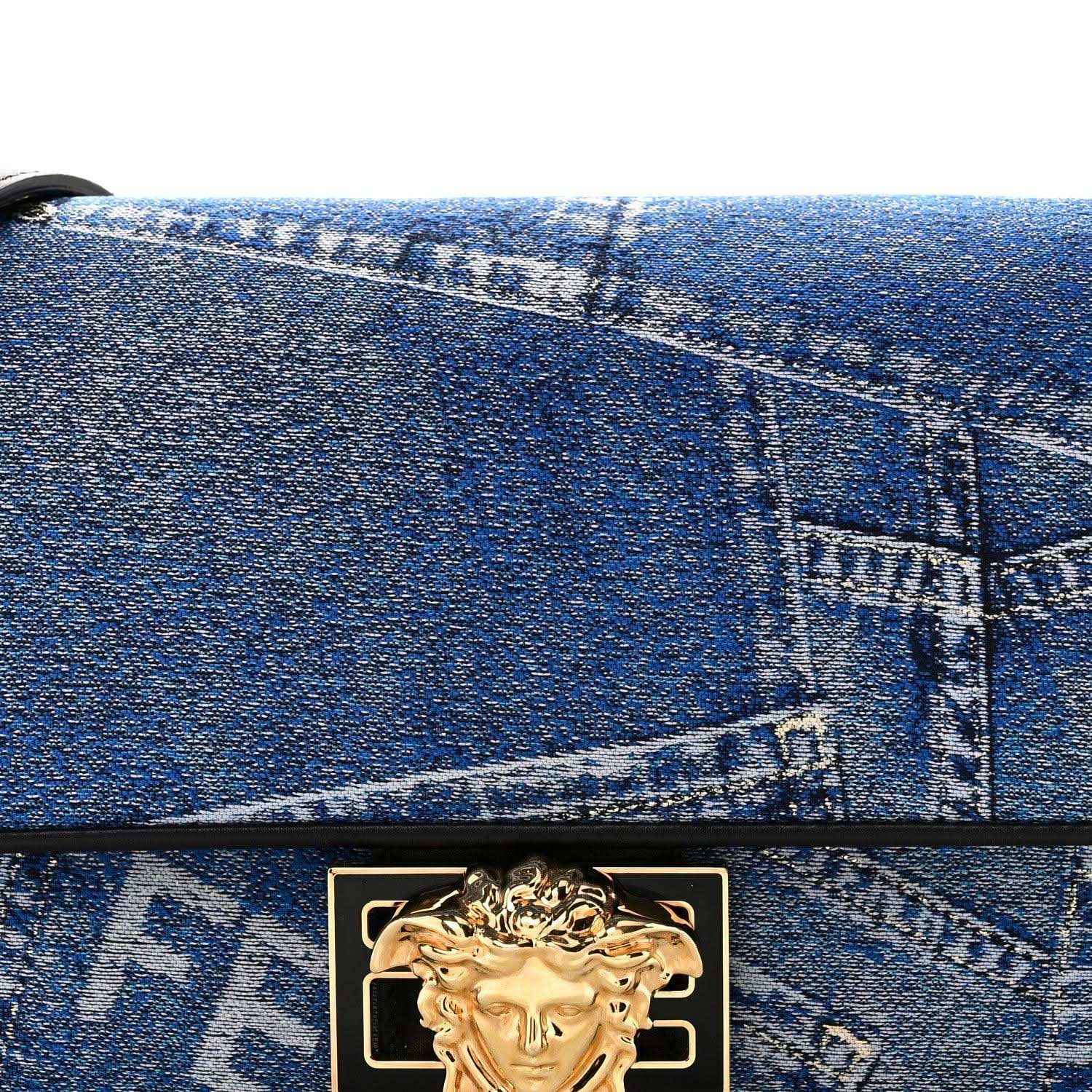 Blue denim patchwork front flap with gold clasp emblem and black top edge