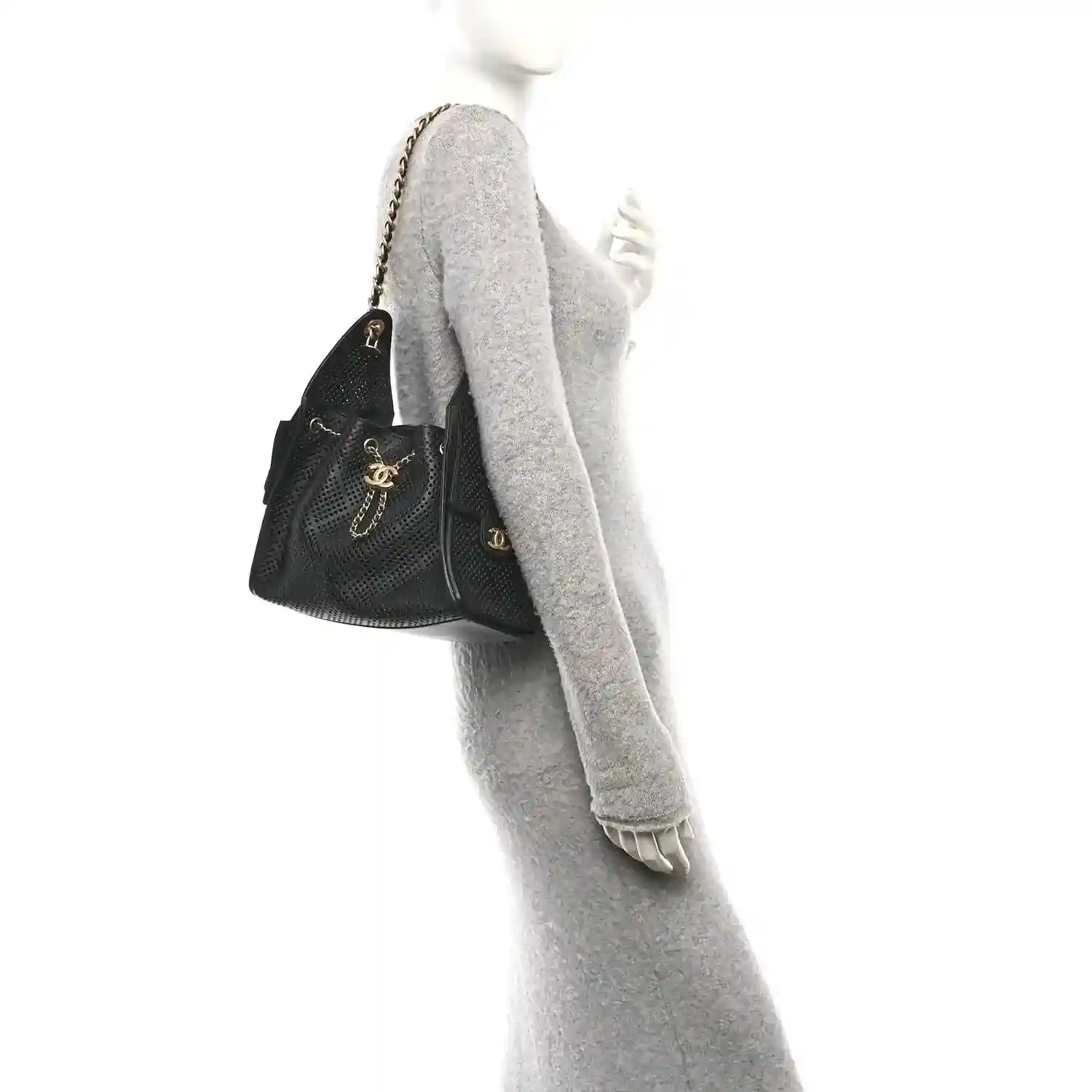 Small black perforated calfskin handbag with chain strap, worn at shoulder