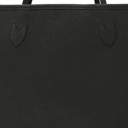 Black textured tote bag panel with stitched seam and embossed pattern