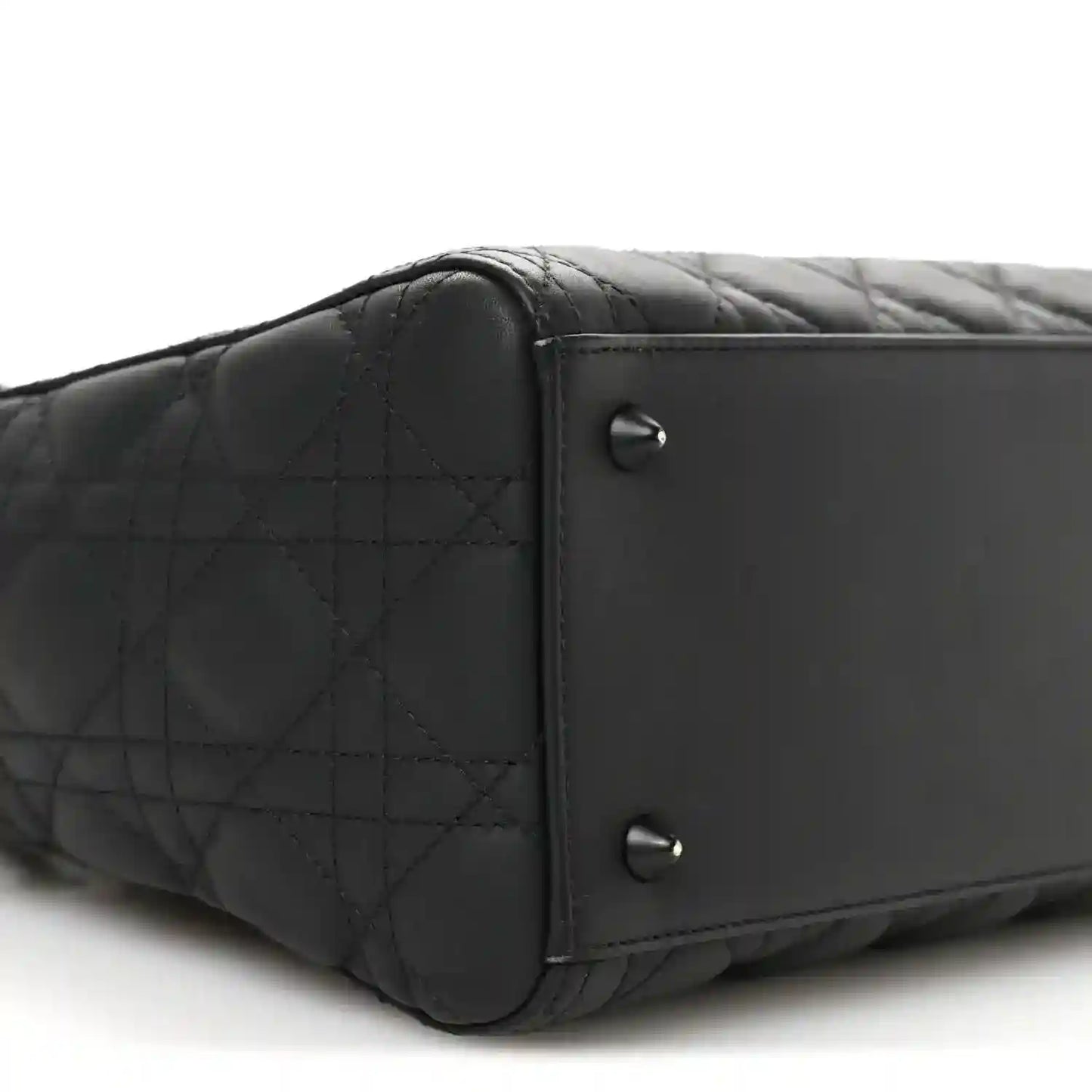 Black quilted Lady Dior bag end panel with two silver-tone rivets