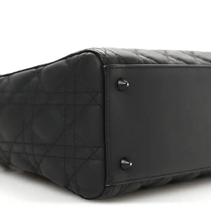 Black quilted Lady Dior bag end panel with two silver-tone rivets