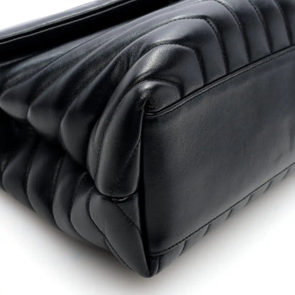Black quilted calfskin satchel corner detail with curved flap trim
