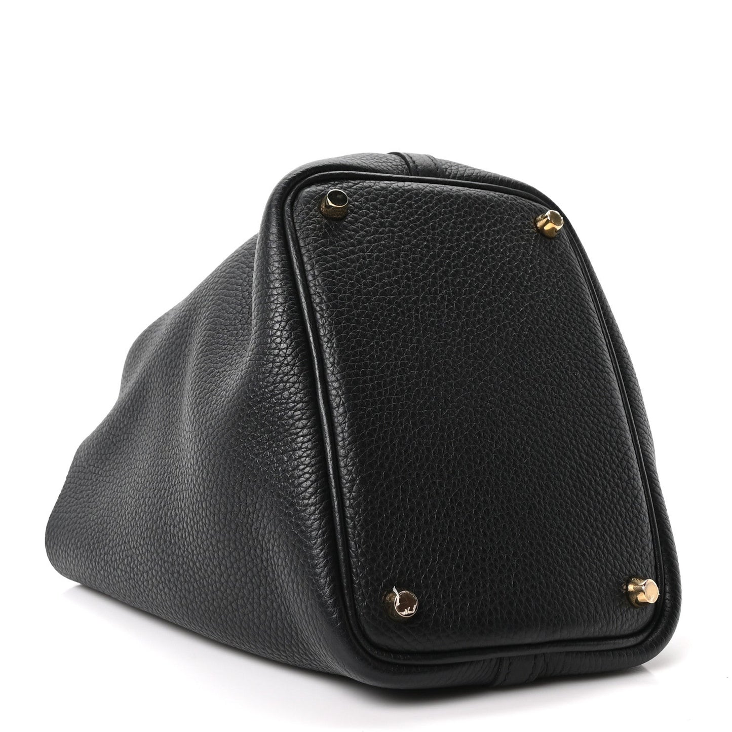 Black pebbled leather tote bag close-up with gold corner hardware and rounded flap