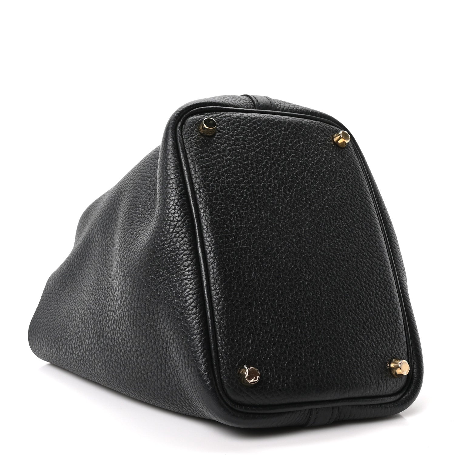 Black pebbled leather tote bag close-up with gold corner hardware and rounded flap