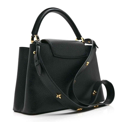 Black Louis Vuitton handbag with long shoulder strap and gold floral logo accents